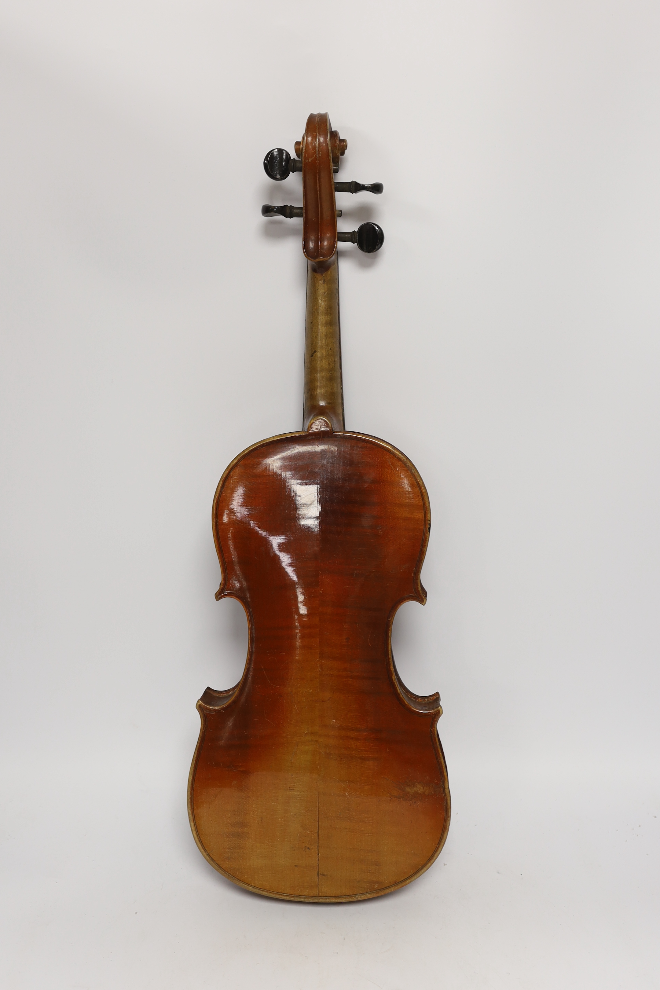 An early twentieth century violin for restoration in an ebonised wooden case, body 36cm (without bow)